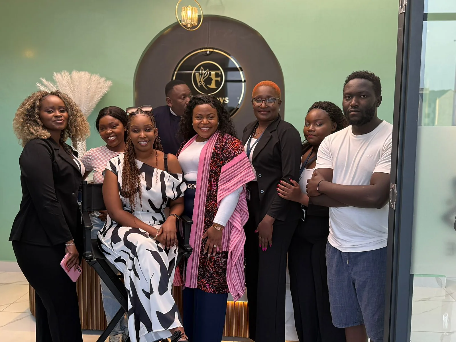 Beauty business owner and salon professionals inside a modern salon