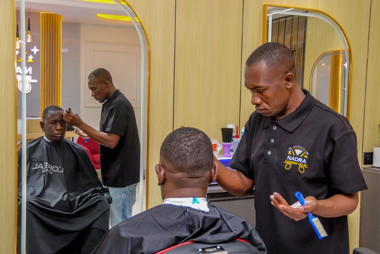 Professional barber providing a client service inside a barbershop