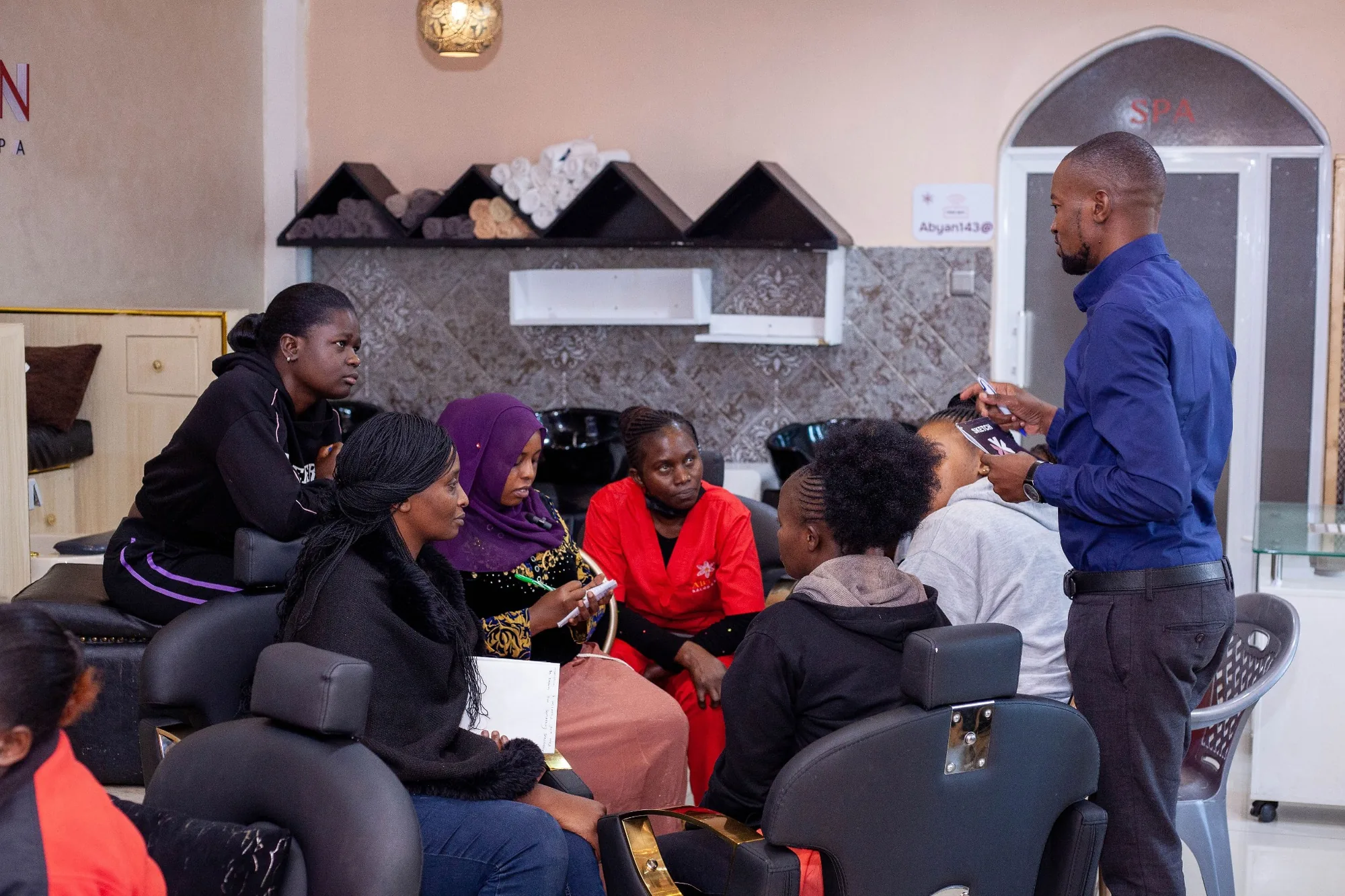 Salons Assured team member briefing salon professionals during business training